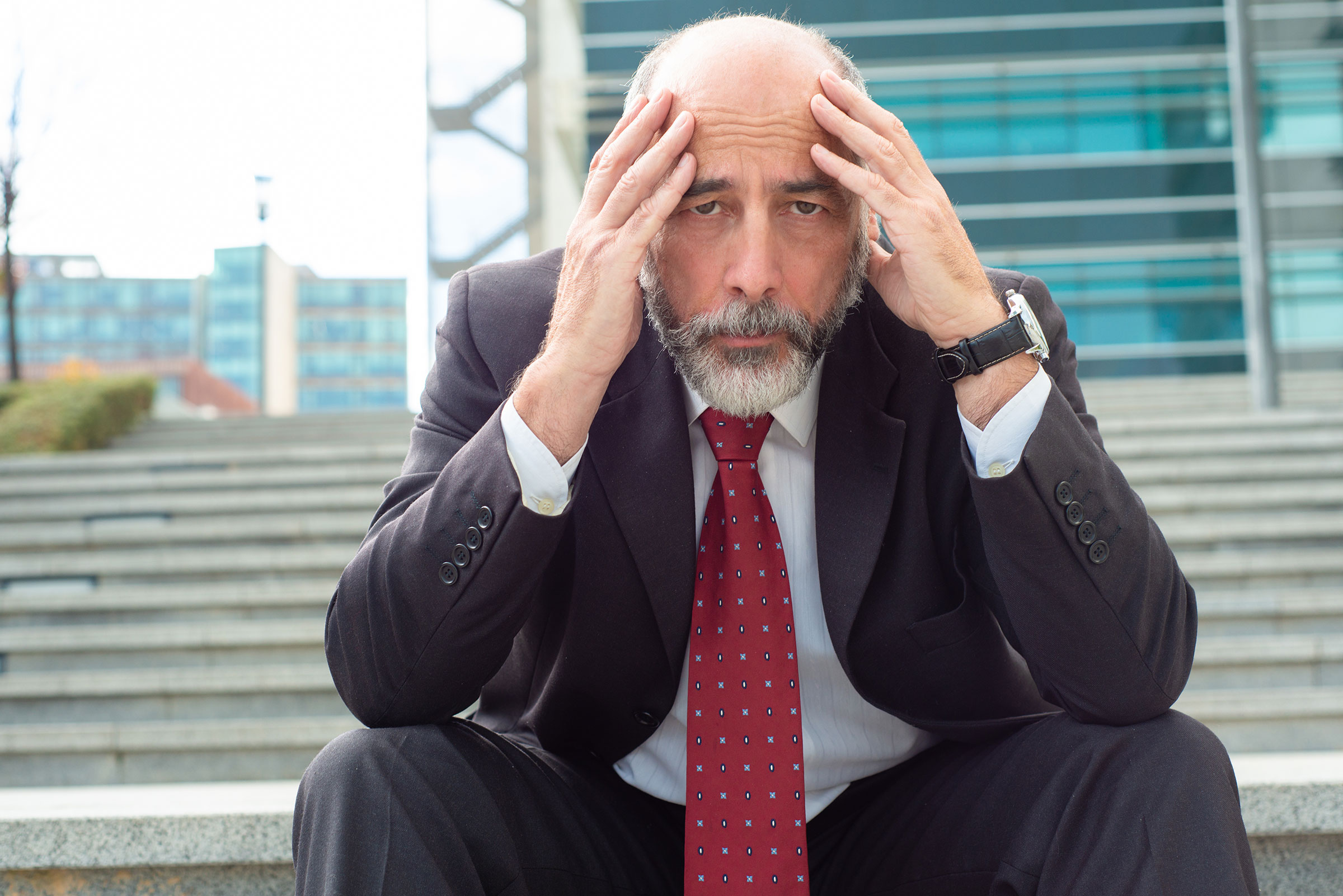 Legal client with head in hands.