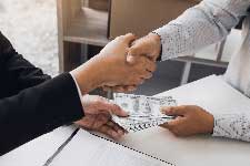 Attorney and client shaking hands.