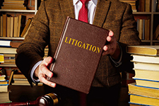 Attorney holding litigation book.