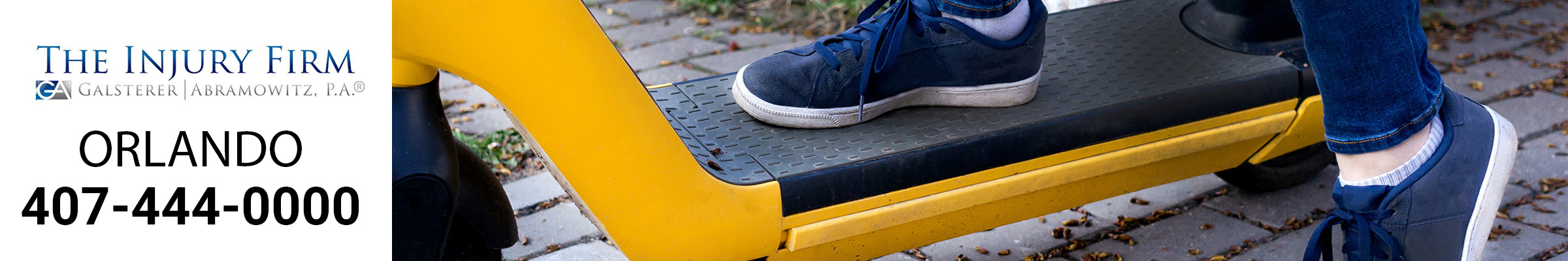 E-Scooter, yellow showing rider's 2 feet.