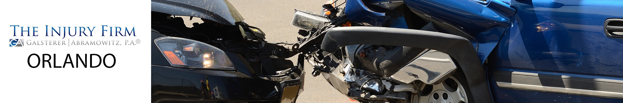 Two cars with significant front-end damage after a head on collision, pictured next to a banner for The Injury Firm, Orlando.