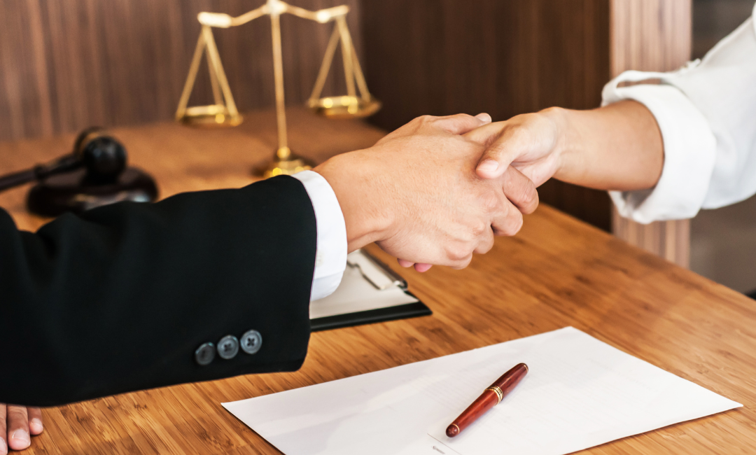 slip and fall victum and lawyer hand shake