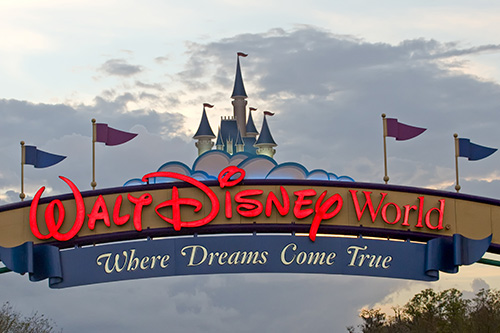 Show thumbnail preview Entrance sign for Walt Disney World with the Cinderella Castle in the background and the phrase Where Dreams Come True written below the park name. Several colorful flags are on top of the sign.