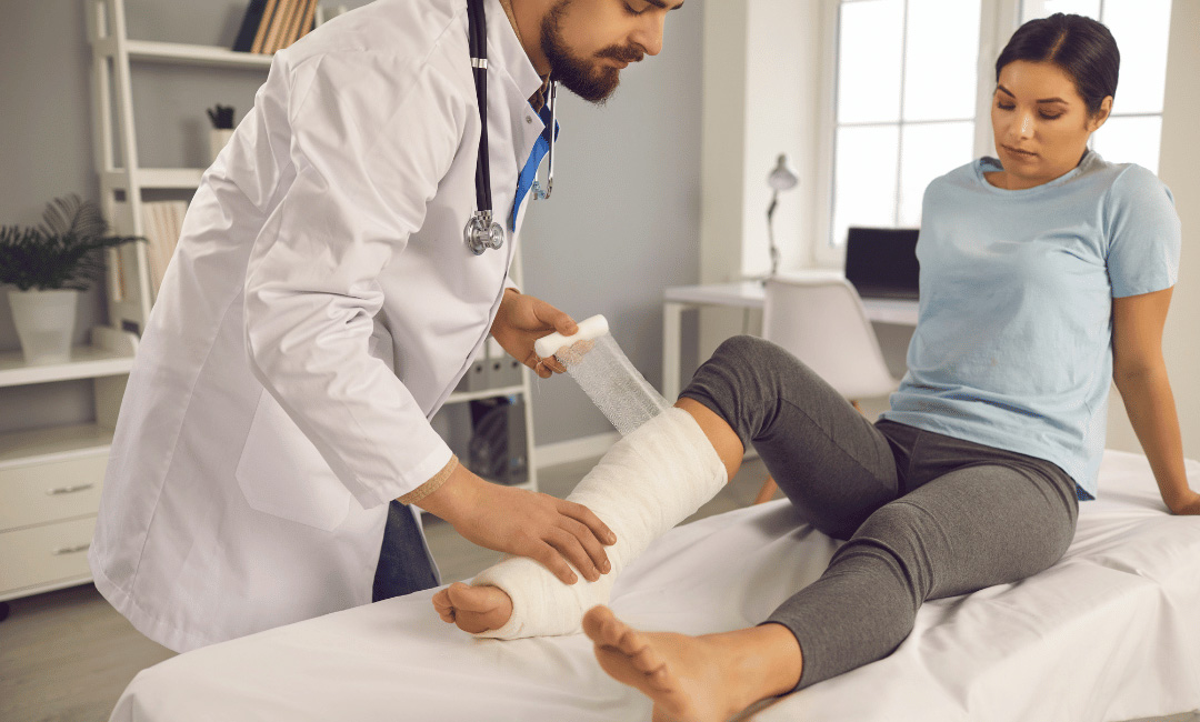 doctor wrapping leg injury from slip and fall accident