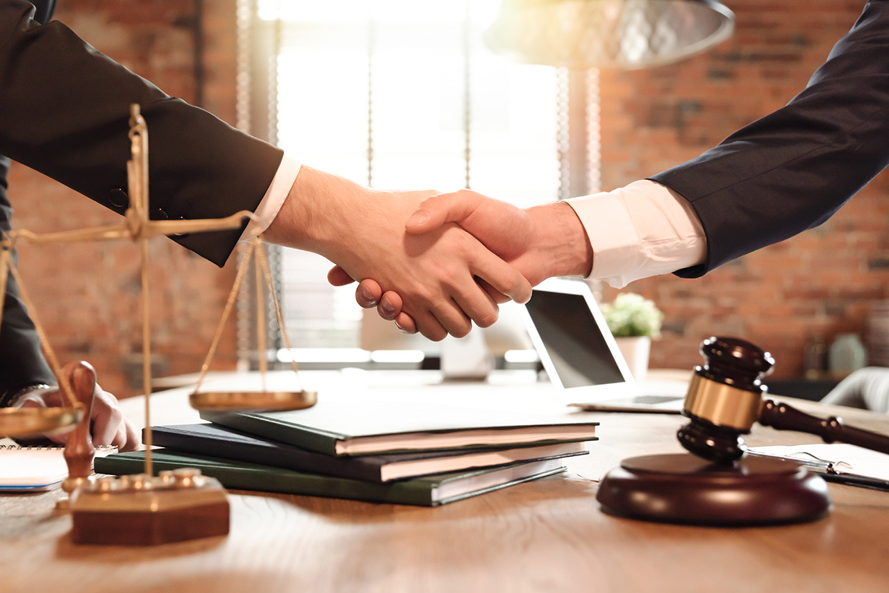 lawyer and client shakiing hands