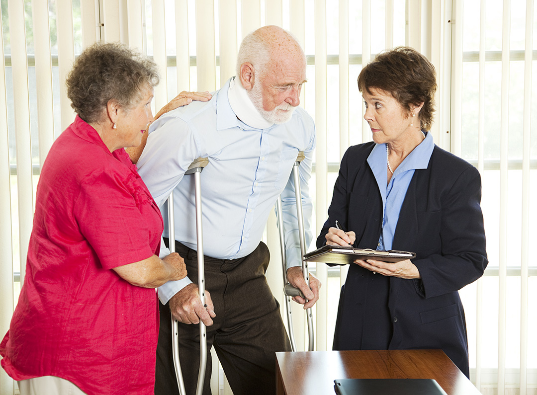 man on crutches with neck brace talking with lawyer