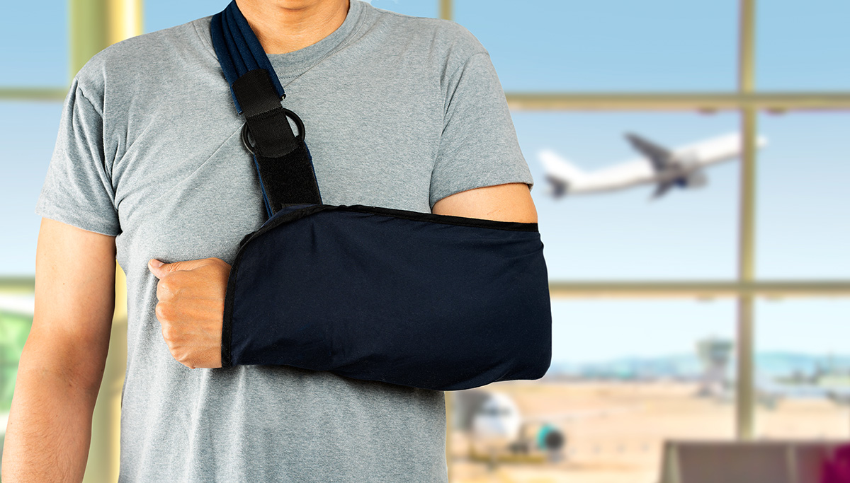 man with arm in sling injured on airplane