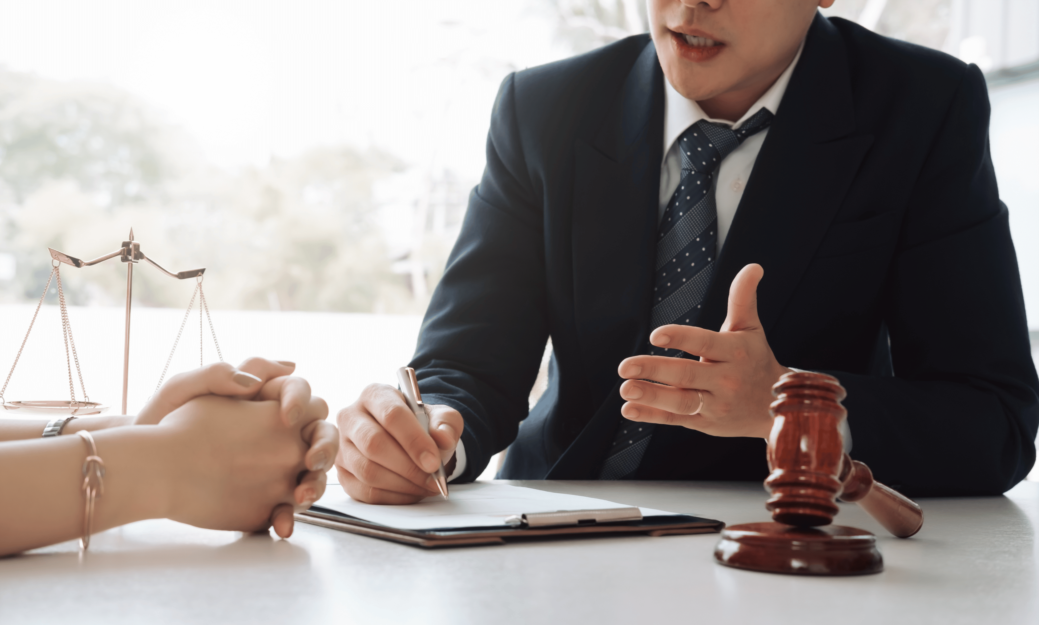 young hansome male attorney disussing birth injury case with client