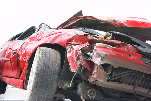 Red car totaled in an accident.