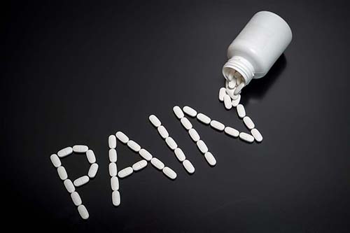 PAIN spelled out with pain pills.