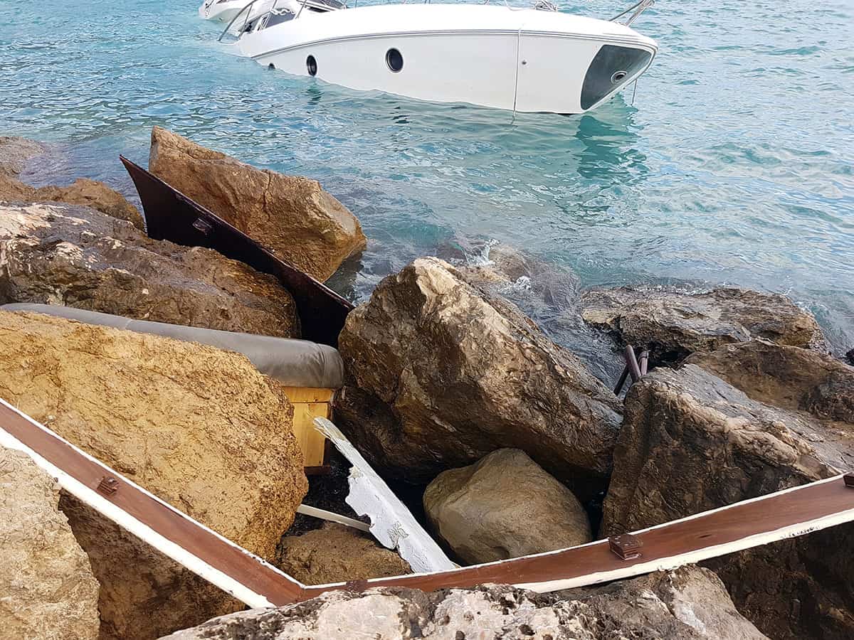 image sinking yacht crashed into rock jetty