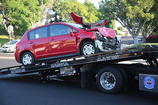 Car on tow truck bed after car accident