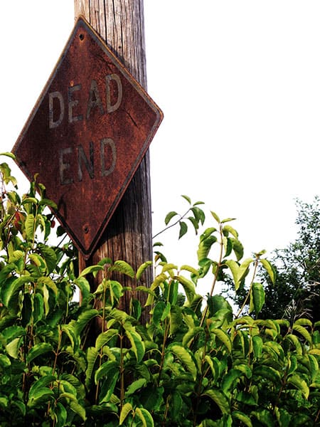 damaged dead end road sign
