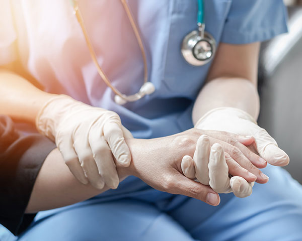 doctor examining swollen wrist after cast removed car accident victim