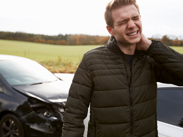 man holding neck after car crash