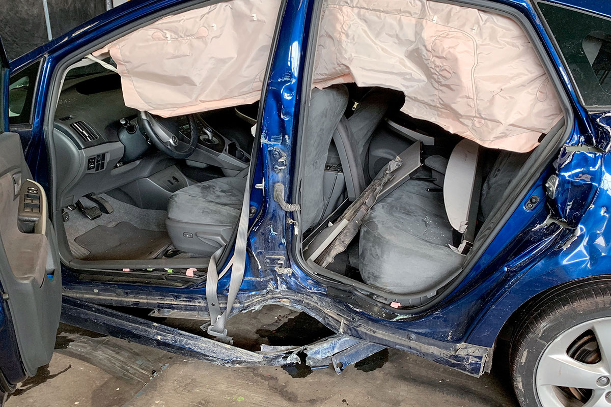T-bone car accident scene showing side impact collision damage