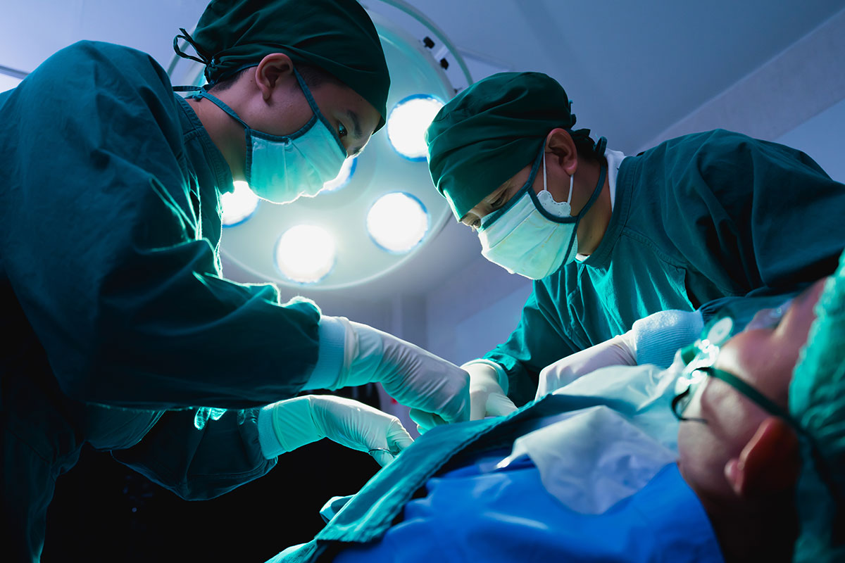 team of doctors operatinig on car accident victim