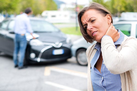 woman feeling pain in neck after car accident