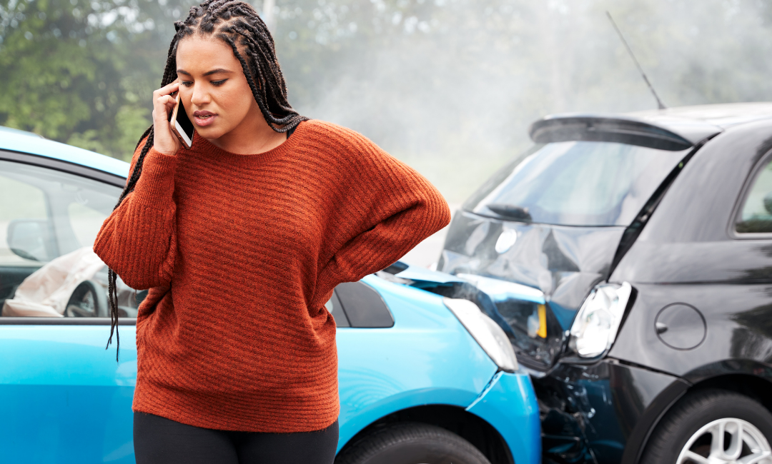 woman-on-phone-lower-back-pain-after-car-accident