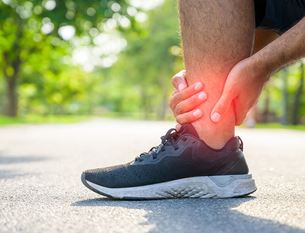 Man holding ankle replacement area do to pain