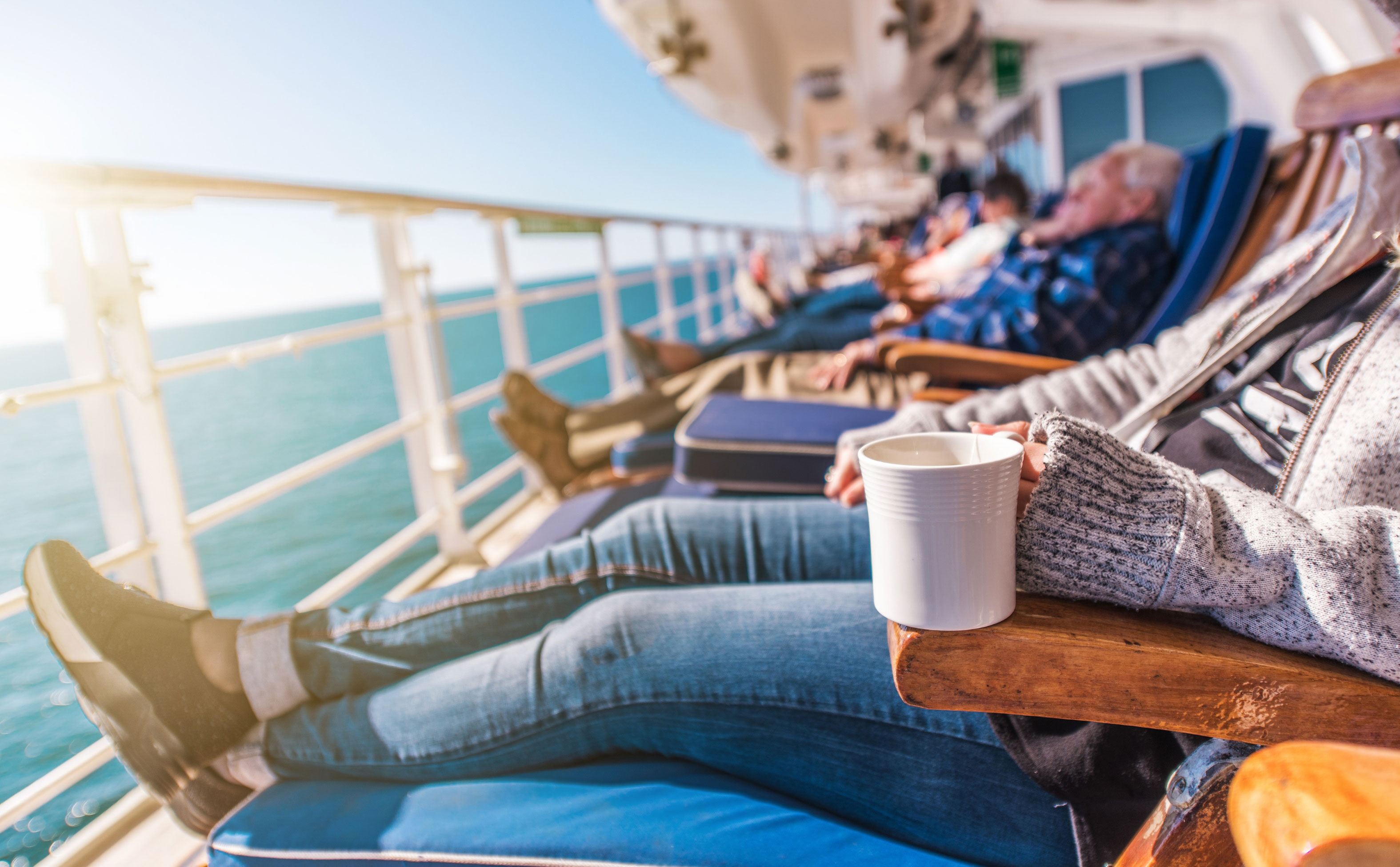 Carnival cruise ship deck chairs filled with people