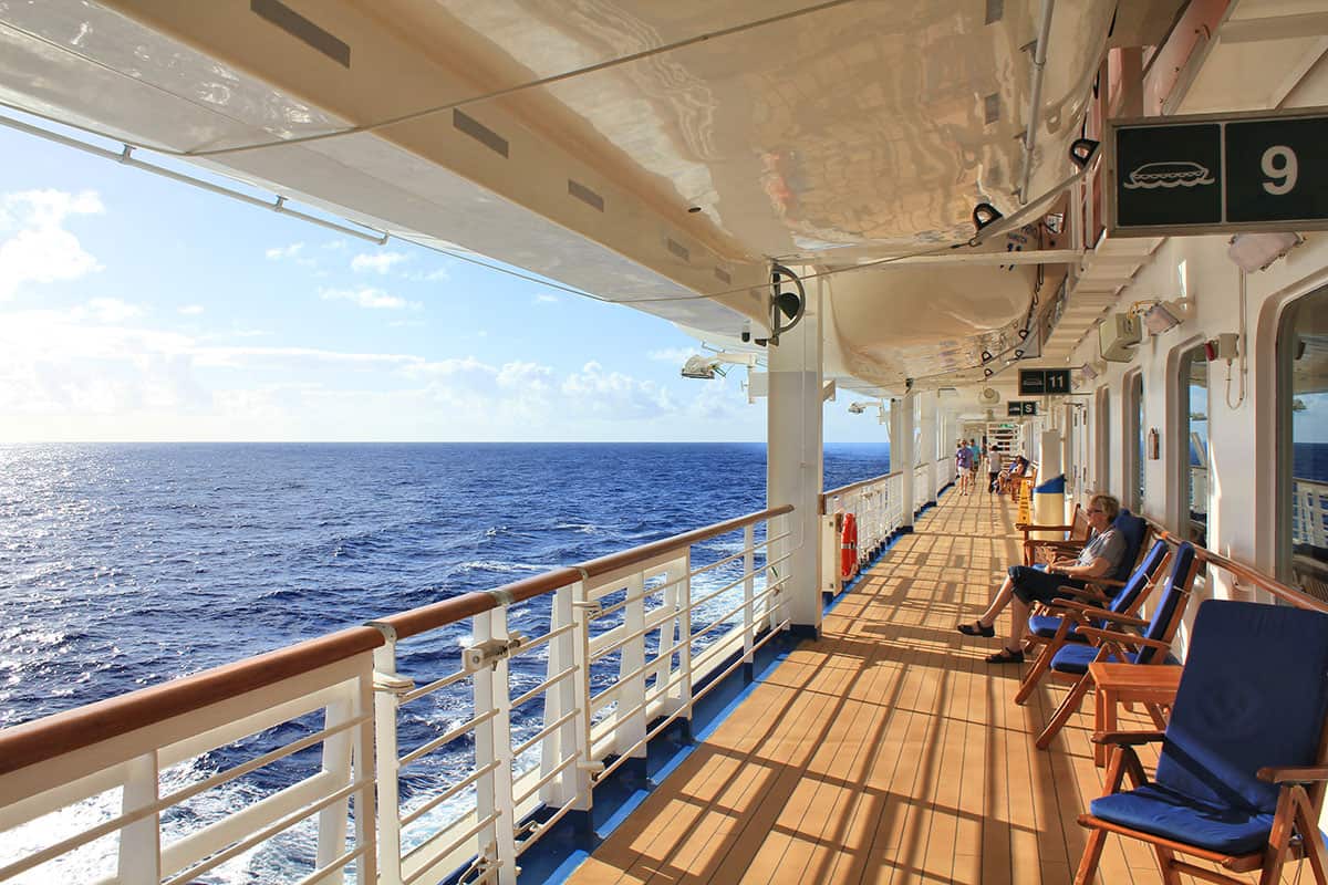 cruise ship passenger in deck chair watching ocean