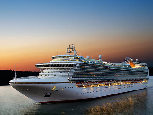 image - large ocean liner at sunset slowly moving parallel to coast