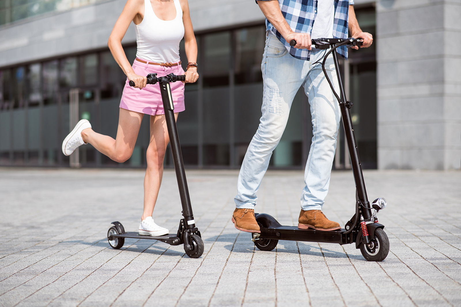 couple riding electric scooters