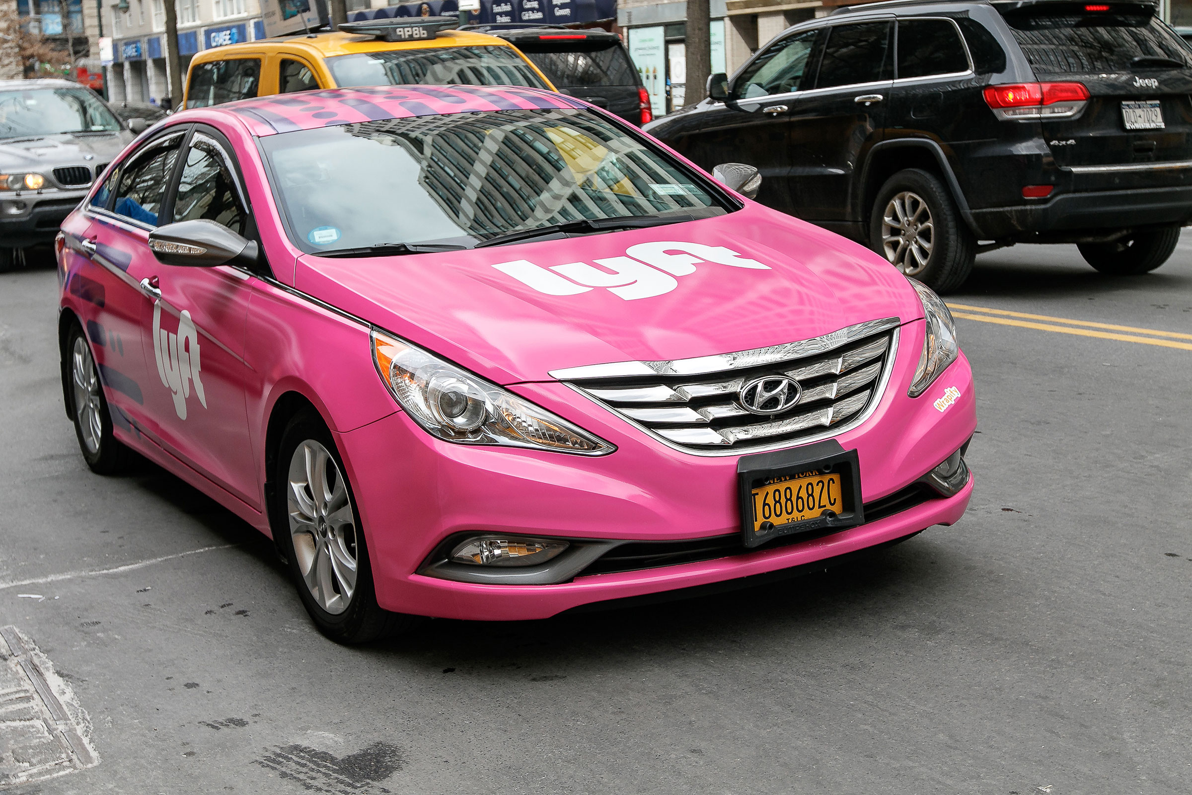 lyft car pink with white lyft logo