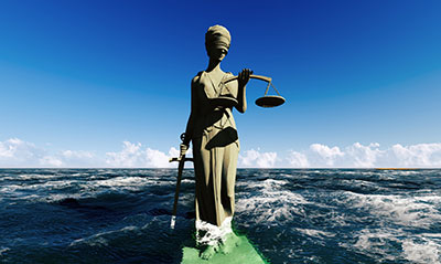 lady of justice standing in ocean