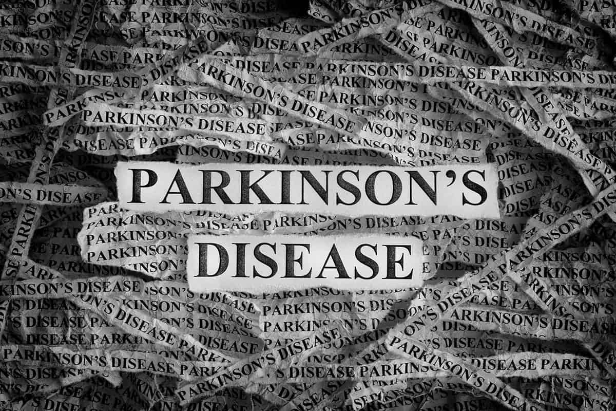 torn pieces of paper wth the words parkinsons disease