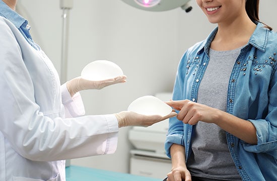  Doctor Showing Silicone Implants to Patient