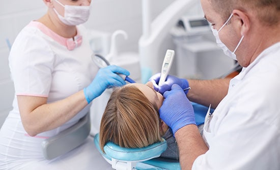 Doctor Dentist Treats Teeth Of Beautiful Young Girl Patient