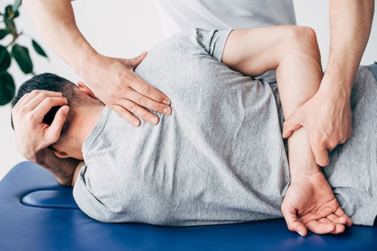 Back view of chiropractor back manipulation