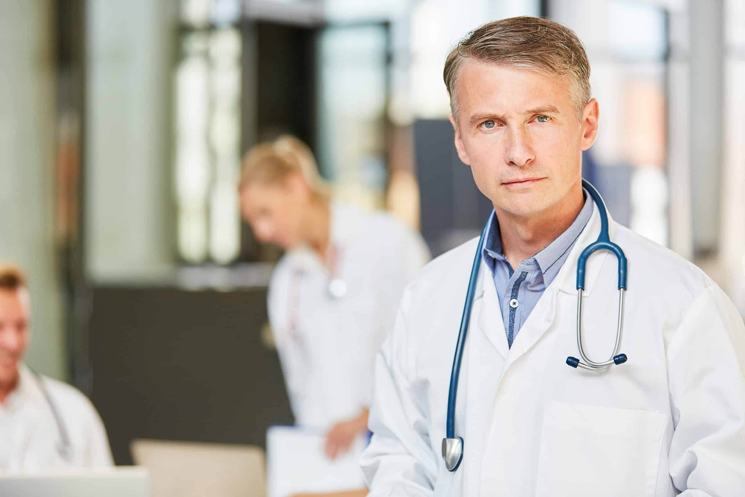Medical doctor in room with two collegues