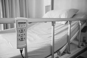 hospital bed with rails up
