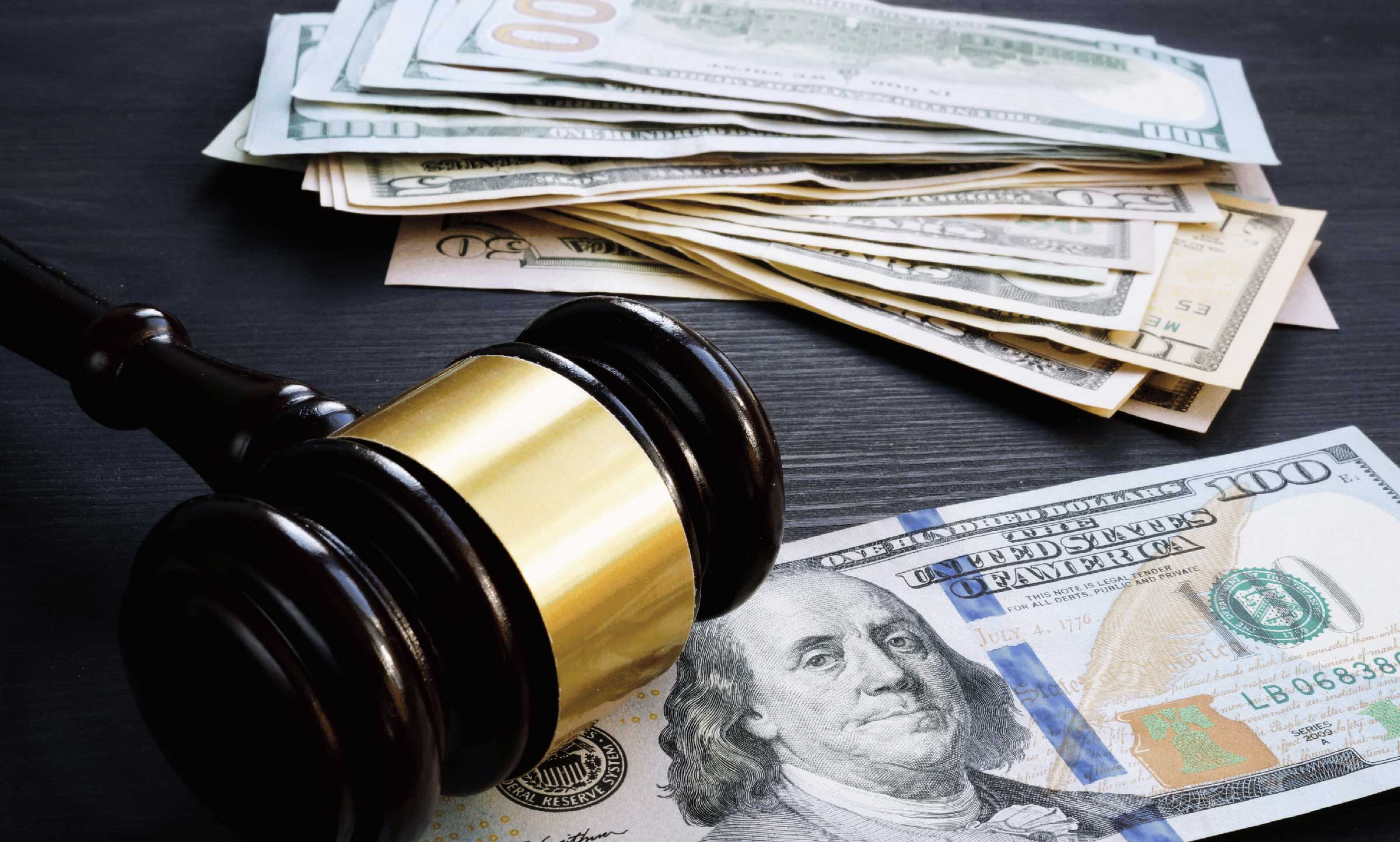 cash on table representing lawsuit settlement