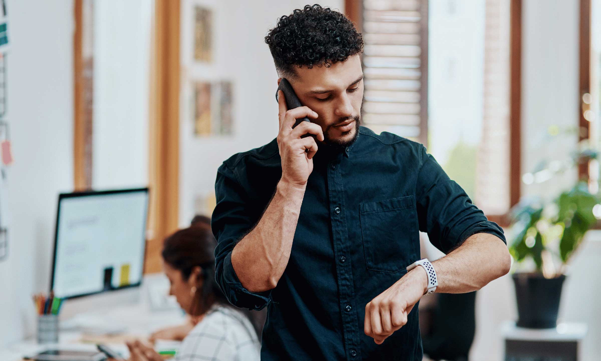 man impatiently lookiing at watch on arm