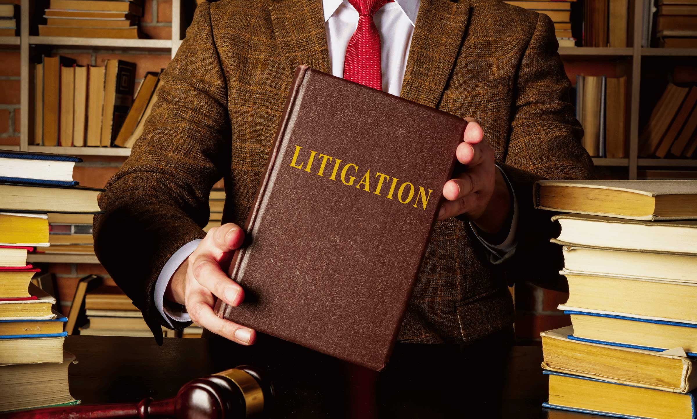 man in suit holding book with title litigation