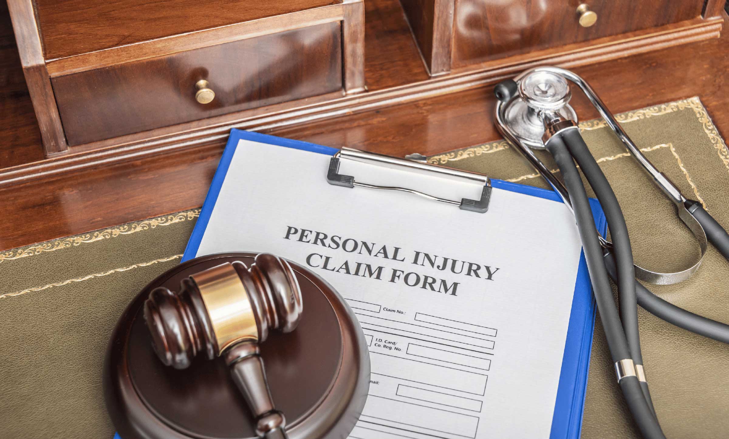 personal injury claim form stethescope and court gavel