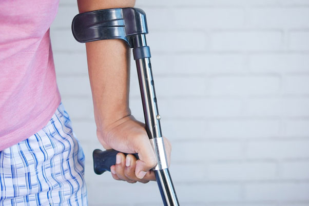 injured man with metal crutch