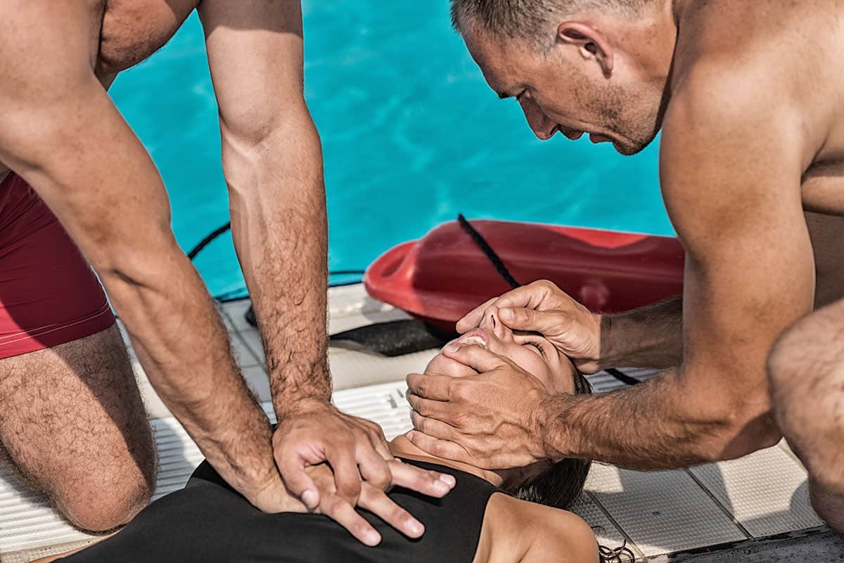 lifeguards performing cpro on swimming pool drowning victim