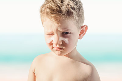 Boy With Sunscreen On His Face at ocean