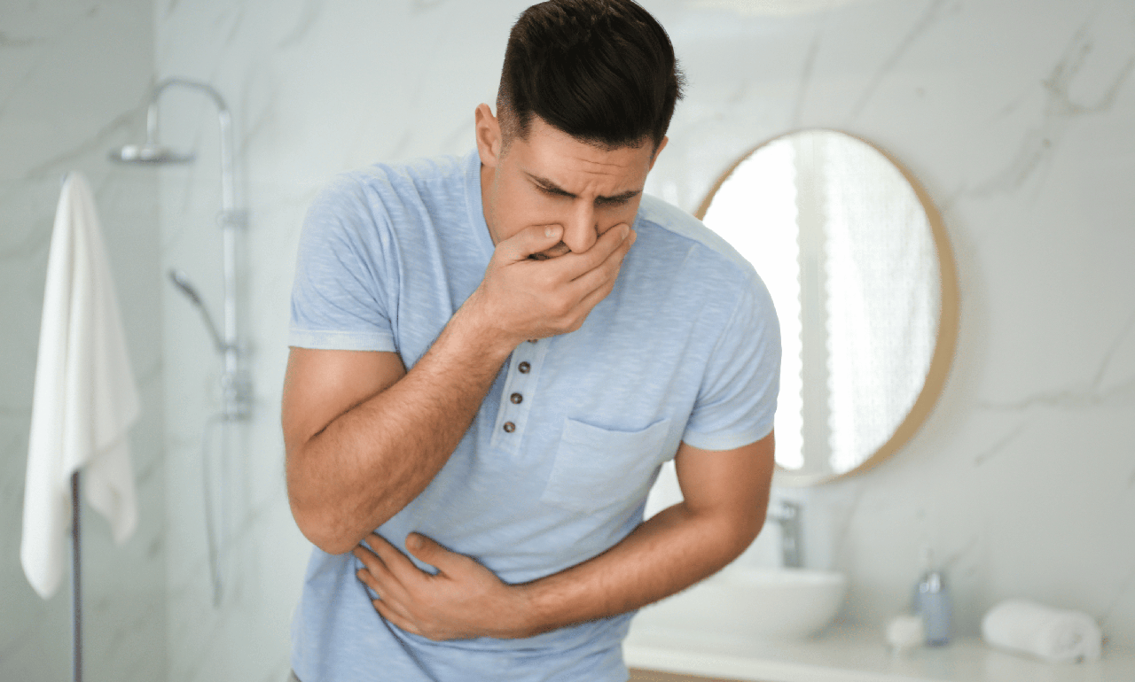 man holding stomach and mouth food poisoning