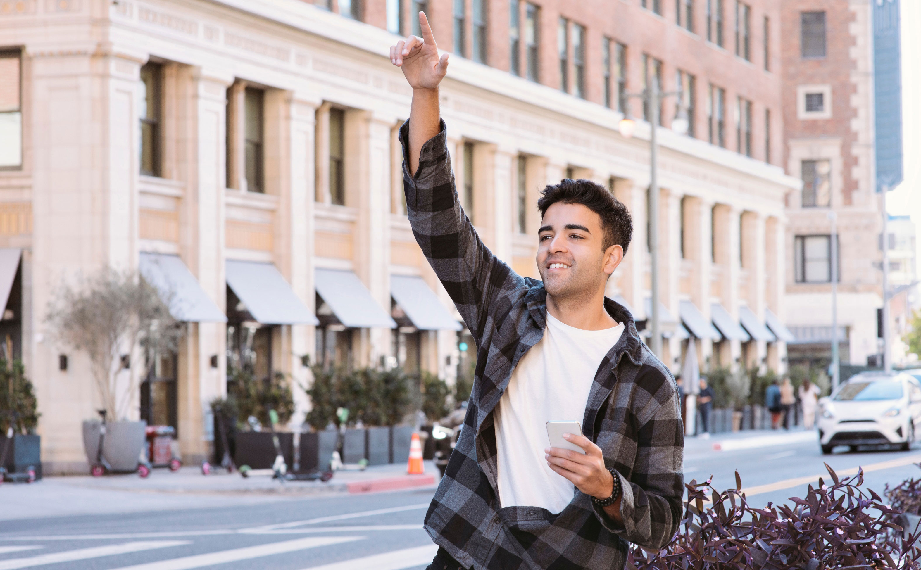 young man flagging Lyft driver foro his ride