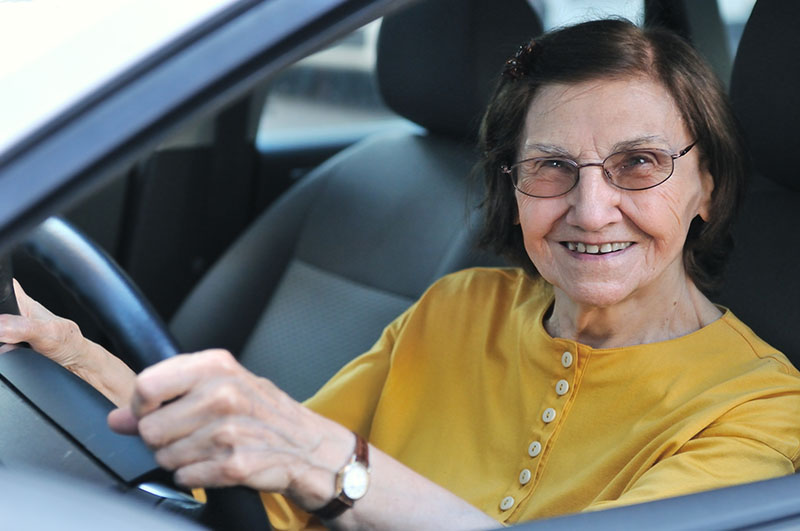 Senior lady driving automobile