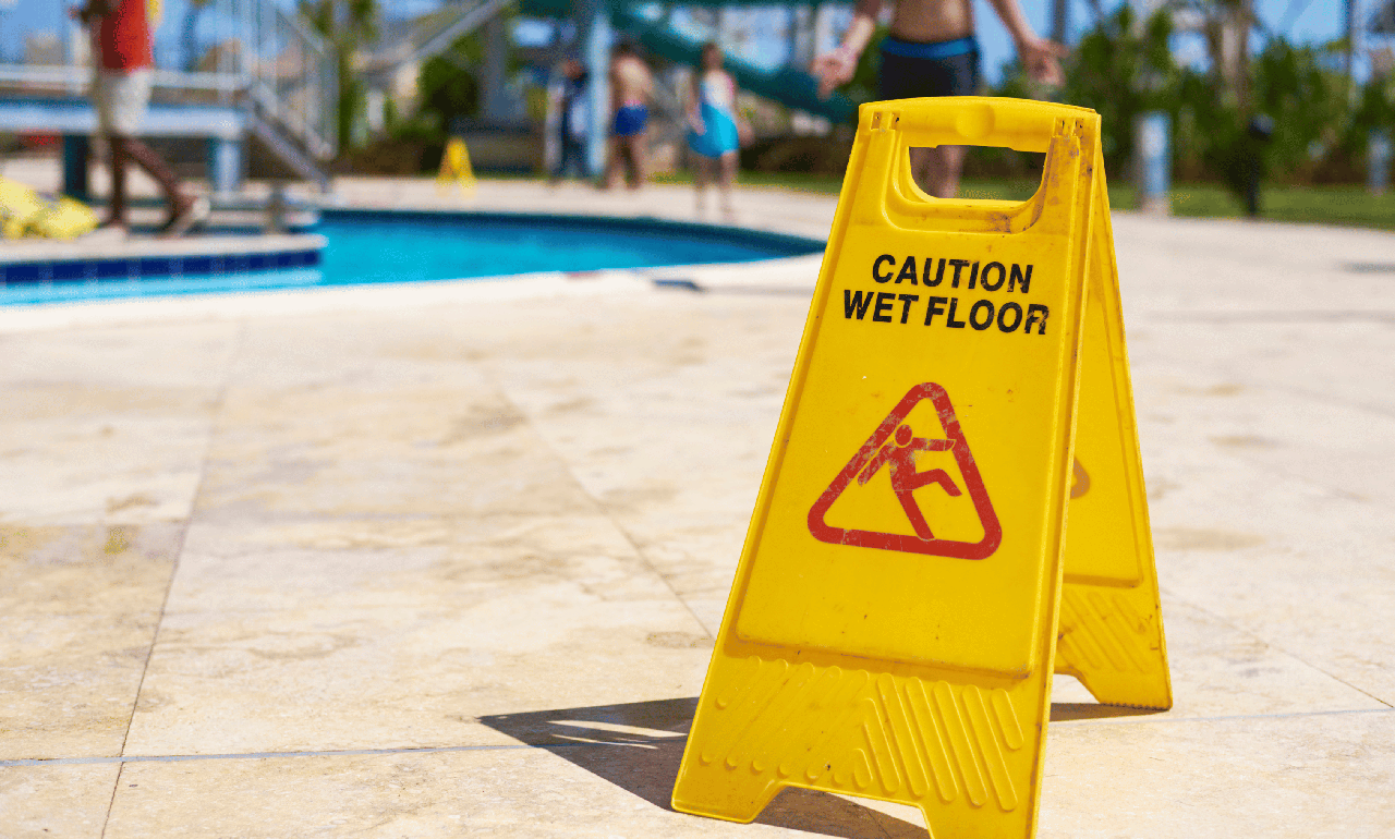 Slippery when wet sign on pool deck