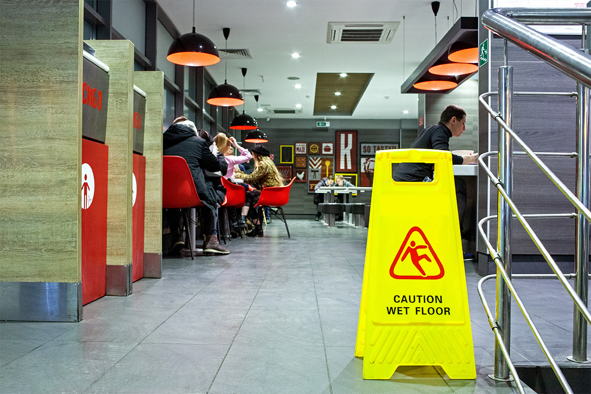 Sign showing warning of caution wet floor in a KFC restaurant