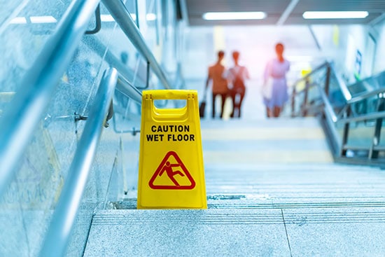 Caution wet floor sign in stairway at a shopping center