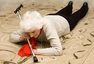 slip and fall accident by senior citizen lady laying on floor with cane